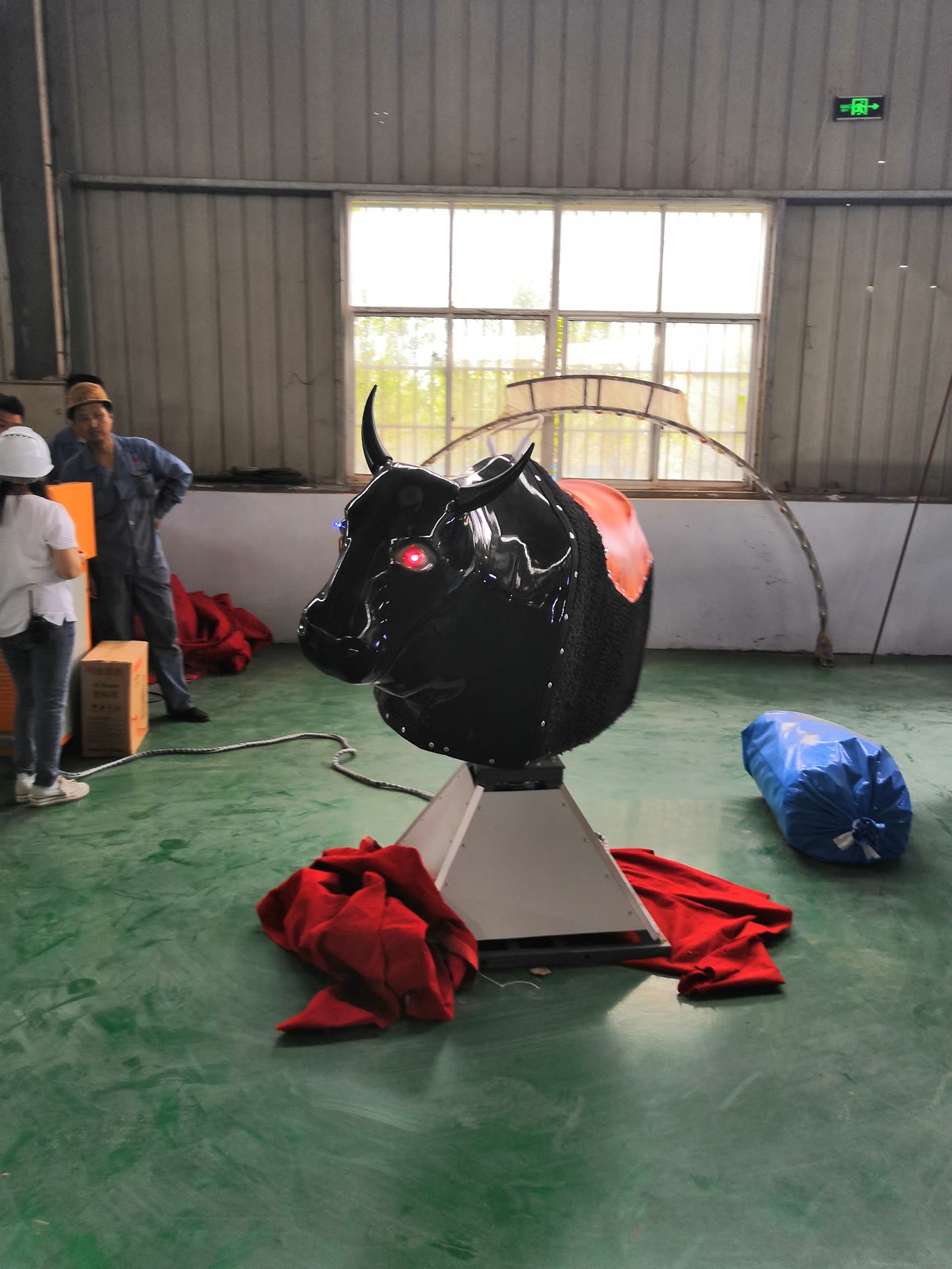 Black mechanical bull side profile in workshop