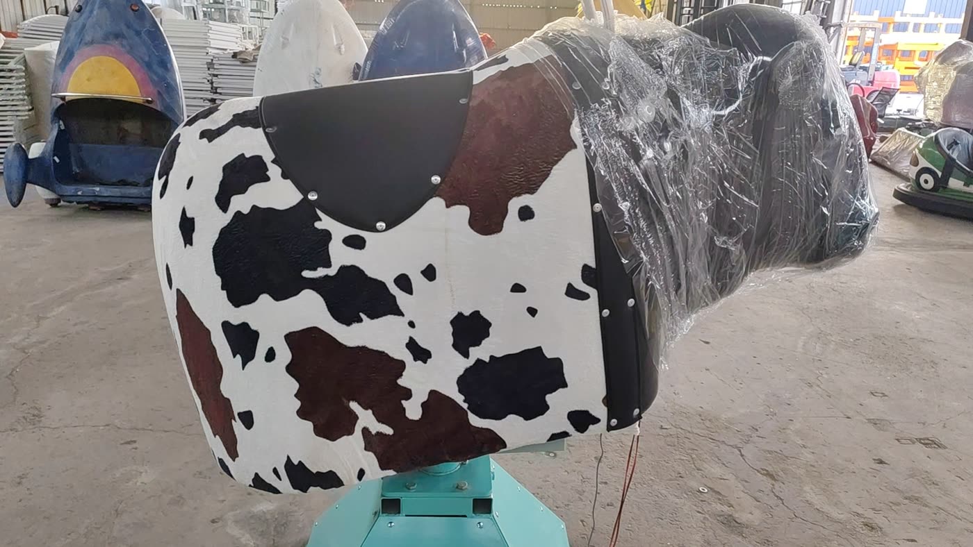 Cow-print mechanical bull ride for family venues