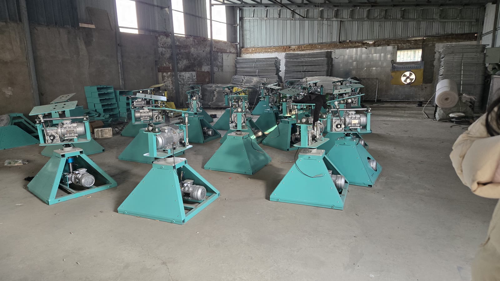 Rows of mechanical bull drive bases on the factory floor