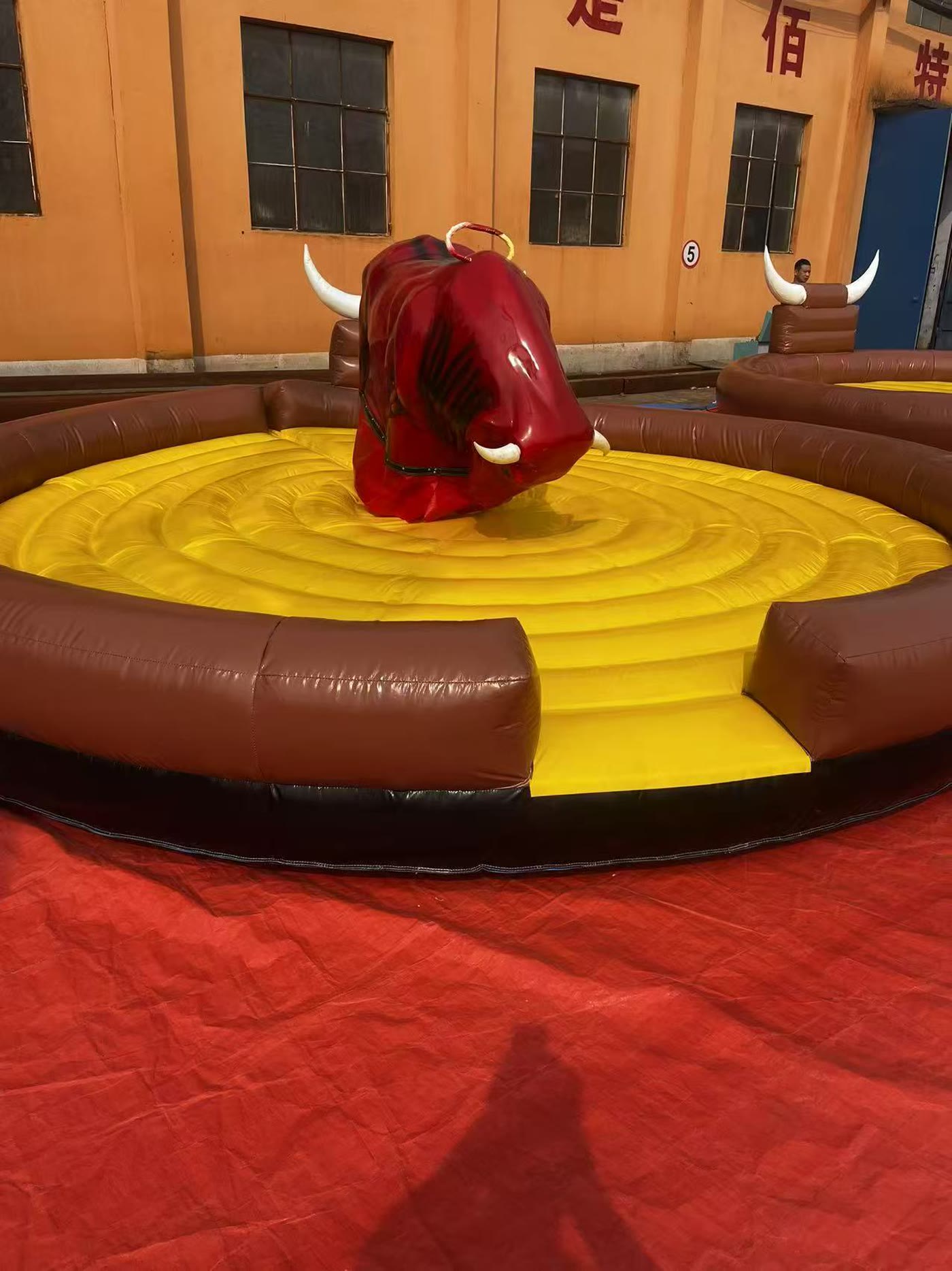 Mechanical bull running under floodlights at a night event
